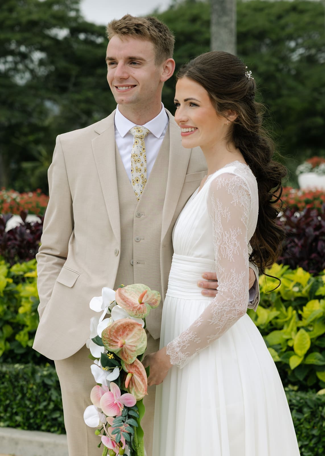 Couple standing outside of the Laie Temple after their wedding in Oahu